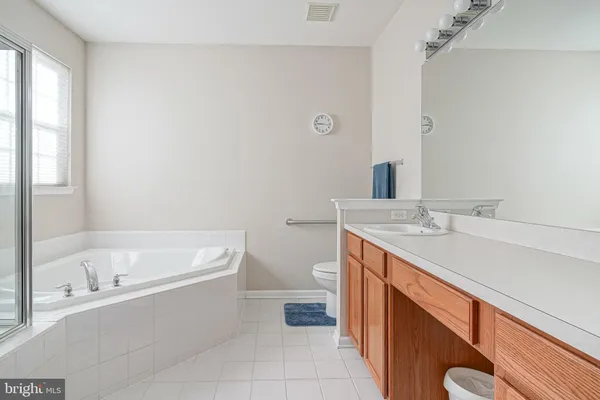 a bathroom with a sink a toilet and bathtub