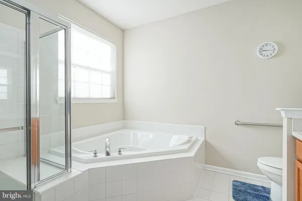 a white bath tub sitting next to a toilet