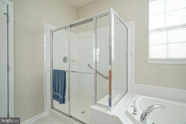 a bathroom with a shower and a sink