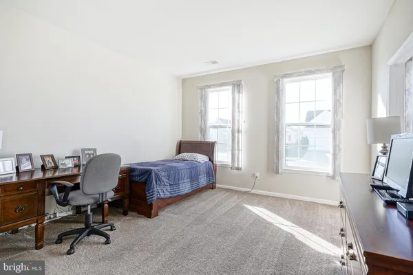 a bedroom with a bed chair and a window