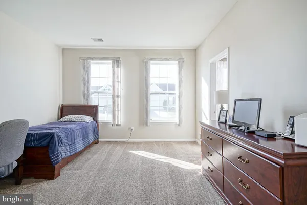 a spacious bedroom with a bed and a window