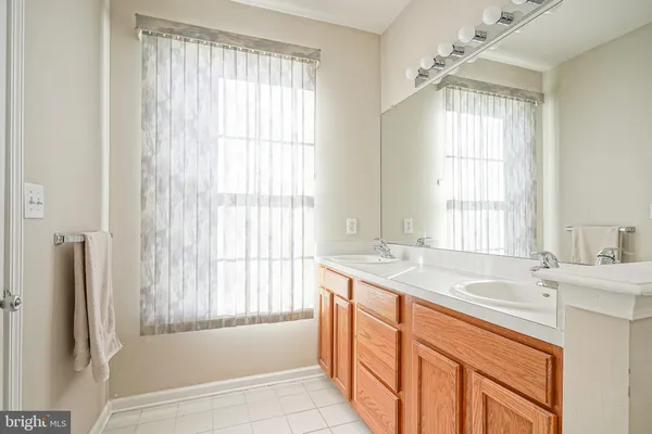 a bathroom with a granite countertop sink and a bathtub