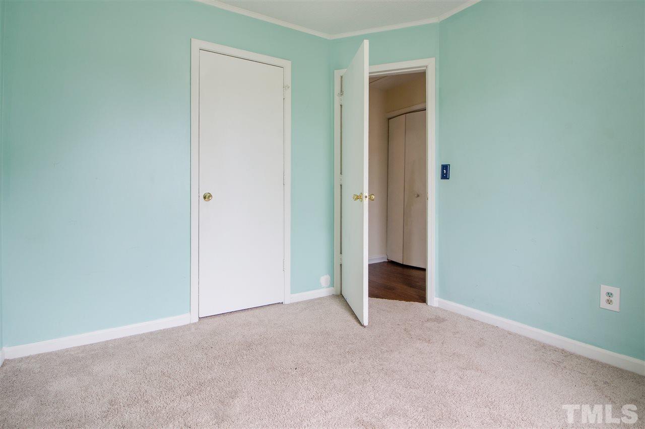 2905 Oneida Court Raleigh, NC 27610 - Photo 17 of 21 an empty room with closet and mirror