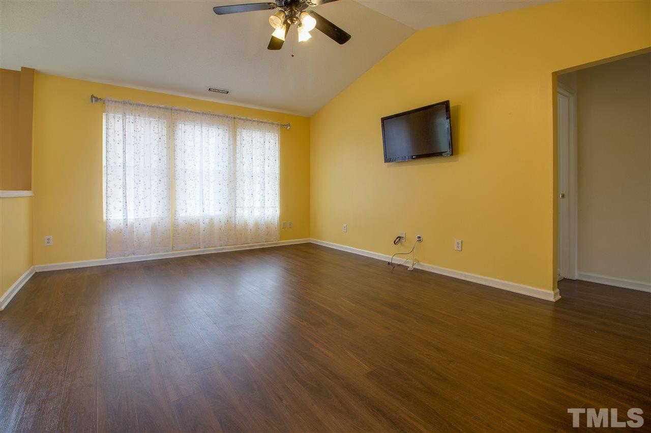 2905 Oneida Court Raleigh, NC 27610 - Photo 5 of 21 a view of an empty room with wooden floor and a window