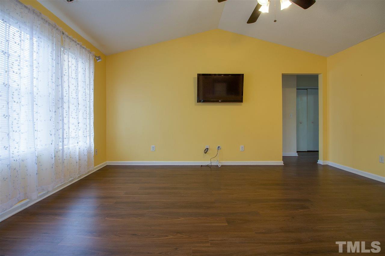 2905 Oneida Court Raleigh, NC 27610 - Photo 6 of 21 a view of an empty room with wooden floor and a window
