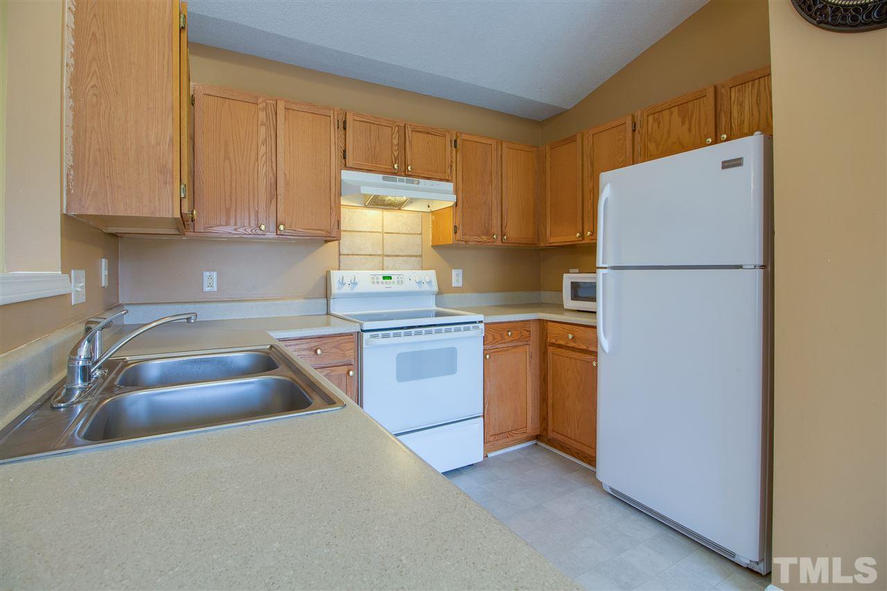 2905 Oneida Court Raleigh, NC 27610 - Photo 9 of 21 a kitchen with sink a refrigerator and cabinets