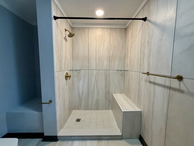 a bathroom with a shower and a tub