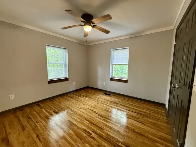 wooden floor in an empty room with a window