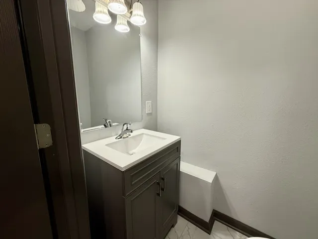 a bathroom with a sink vanity and a mirror