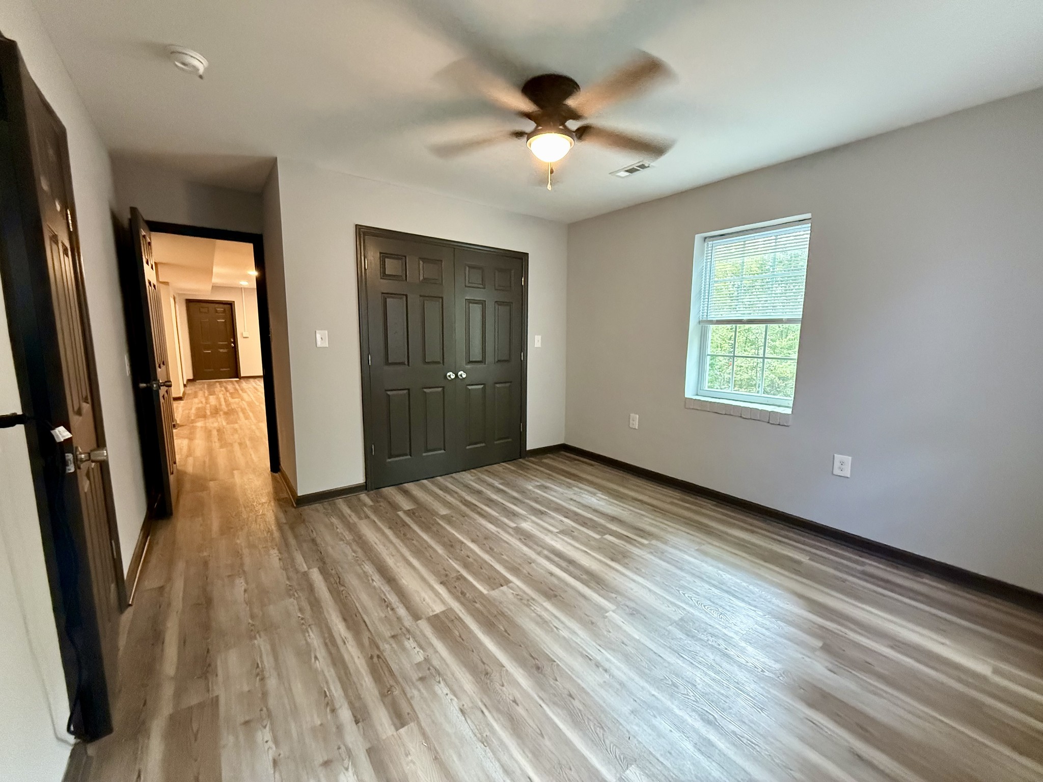 9388 Harrison Ferry Road McMinnville, TN 37110 - Photo 25 of 50 an empty room with wooden floor and a ceiling fan