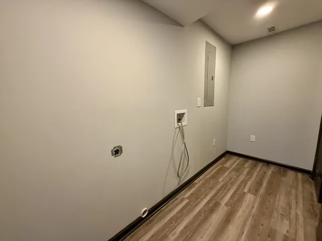 a view of a room with wooden floor and window