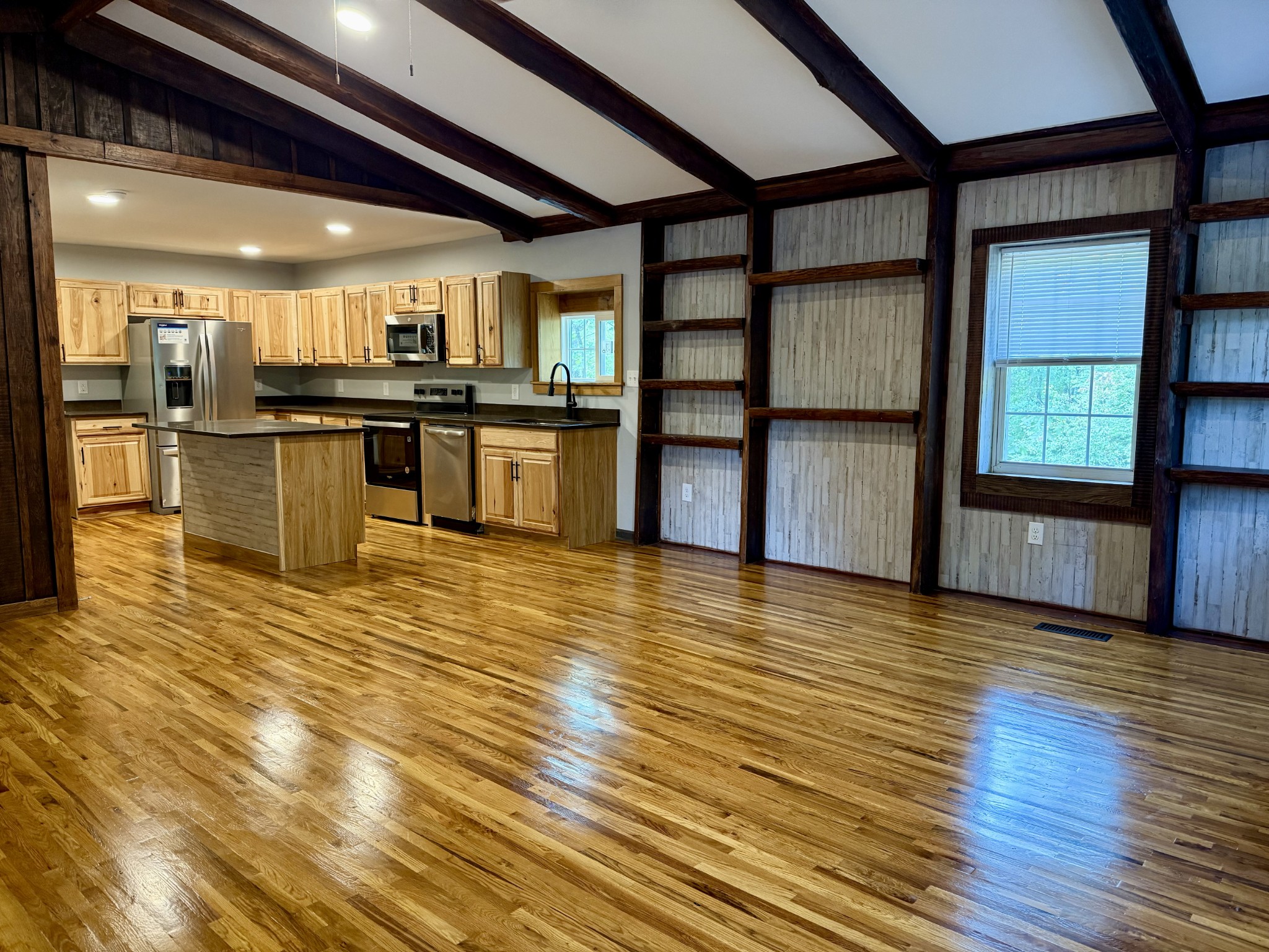 9388 Harrison Ferry Road McMinnville, TN 37110 - Photo 8 of 50 a view of a kitchen with kitchen island a sink wooden floor and stainless steel appliances