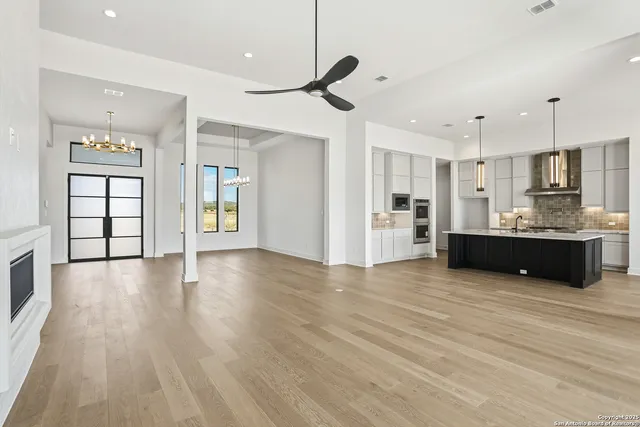 a view of a kitchen with cabinets and wooden floor