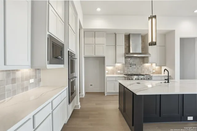 a kitchen with a sink stove and refrigerator