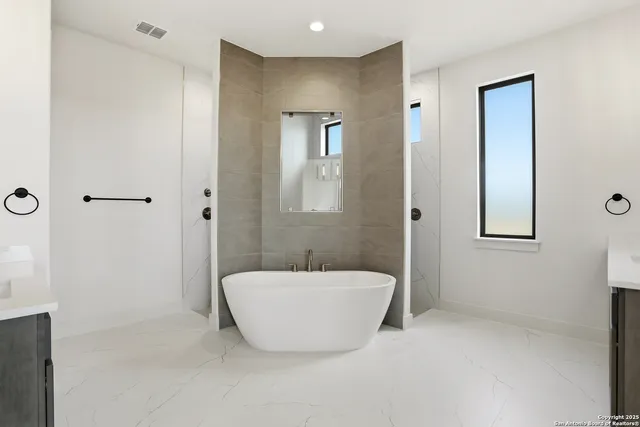 a bathroom with a bathtub and shower