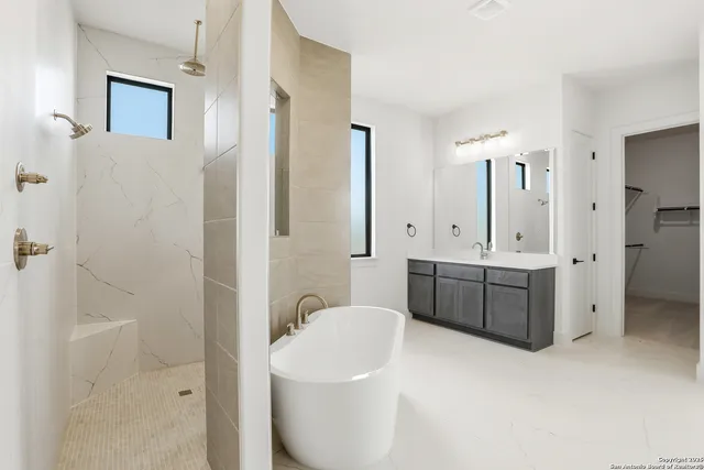 a bathroom with a double vanity sink a toilet a mirror and shower