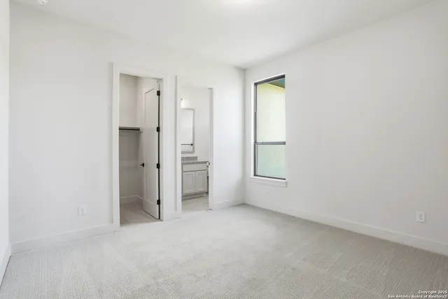 an empty room with windows and closet