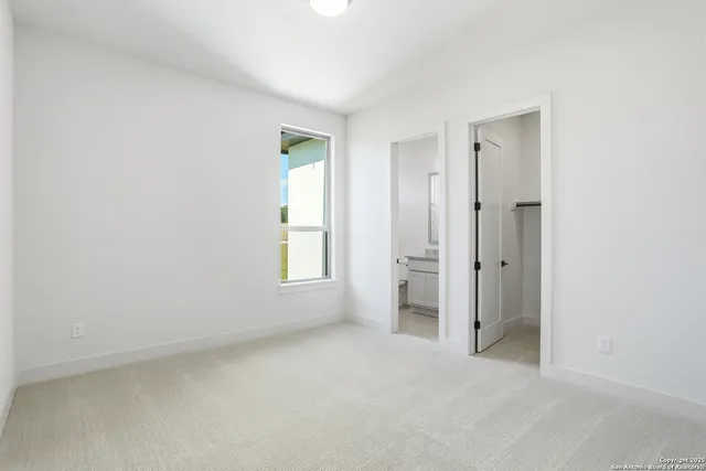 an empty room with windows and closet