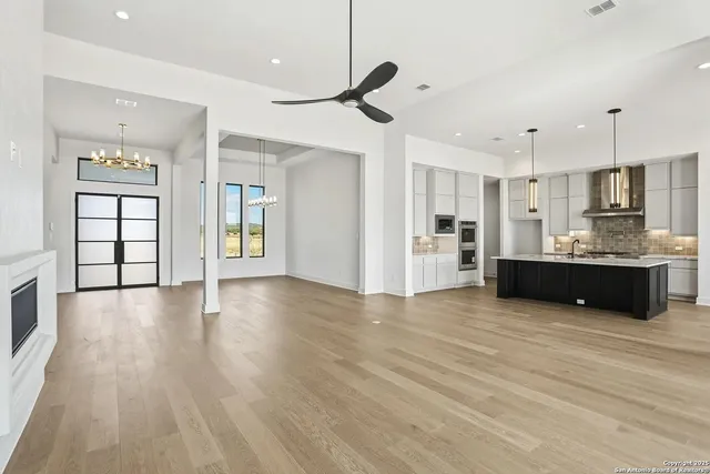 a view of a kitchen with cabinets and wooden floor