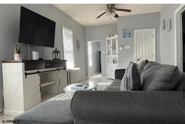 a living room with furniture and a flat screen tv