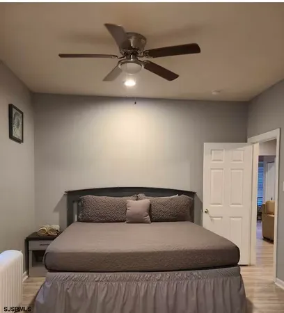 a bed room with a bed and a ceiling fan