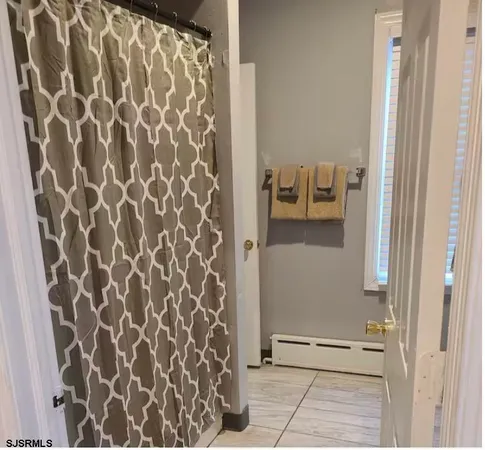a view of bathroom with a shower and a sink