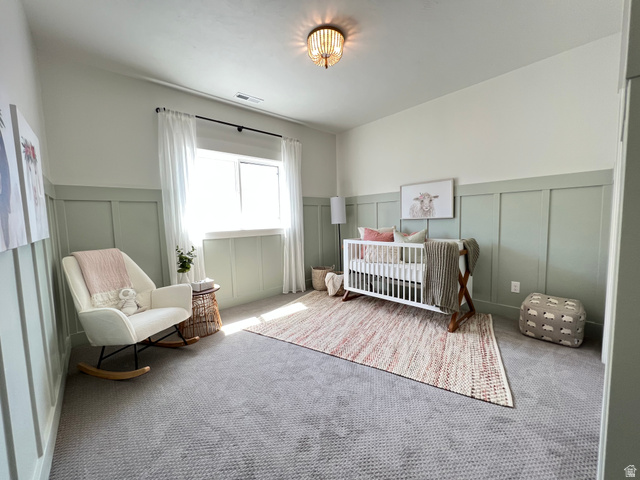1951 2900 West Provo, UT 84601 - Photo 18 of 21 Room featuring board and batten wall detailing, light-colored carpeting, a single window with white curtains, and a ceiling-mounted light fixture