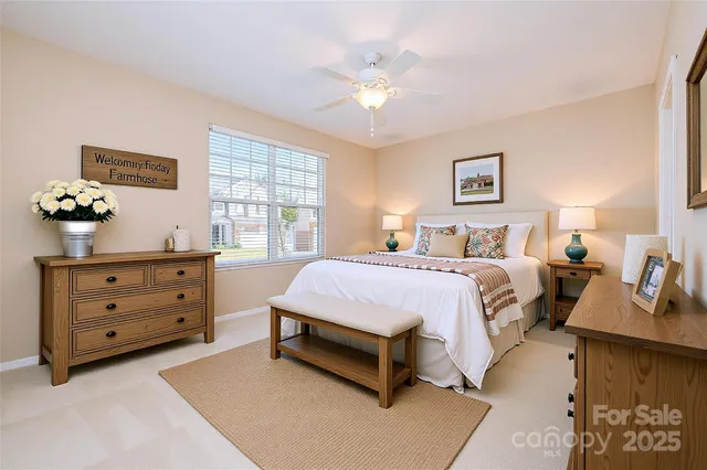 a spacious bedroom with a bed and a dresser