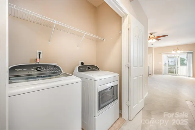 a view of storage and utility room with washer and dryer