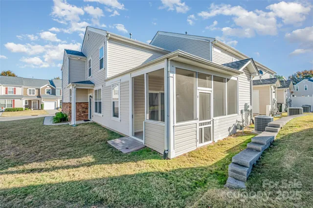 a view of a house with backyard and porch