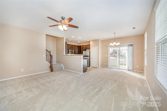 a view of a livingroom with a ceiling fan and window