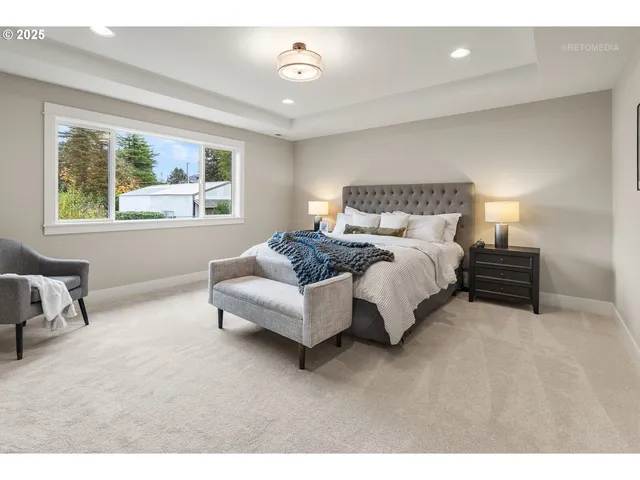 a spacious bedroom with a bed and a large window