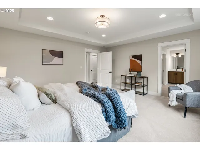 a bedroom with a bed and a chair