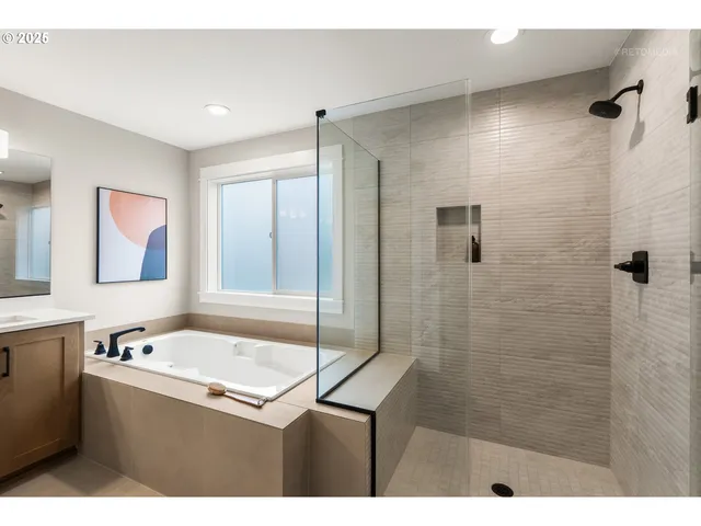 a bathroom with a tub sink and mirror