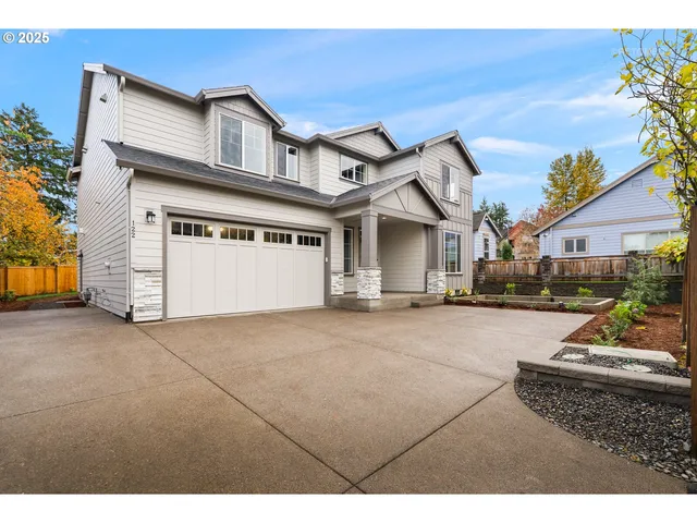 a view of a white house with a outdoor space and a car parked in front of it