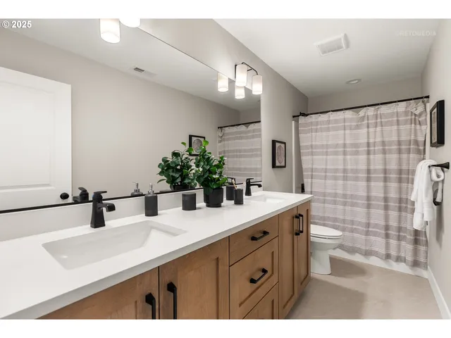 a bathroom with a sink double vanity and a mirror