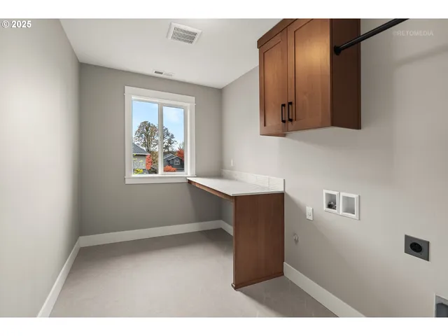 a kitchen with cabinets and wooden floor