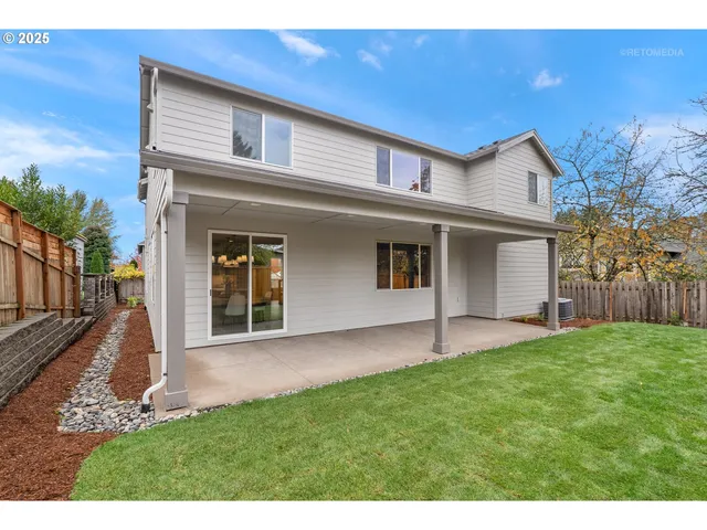 a view of a house with a backyard