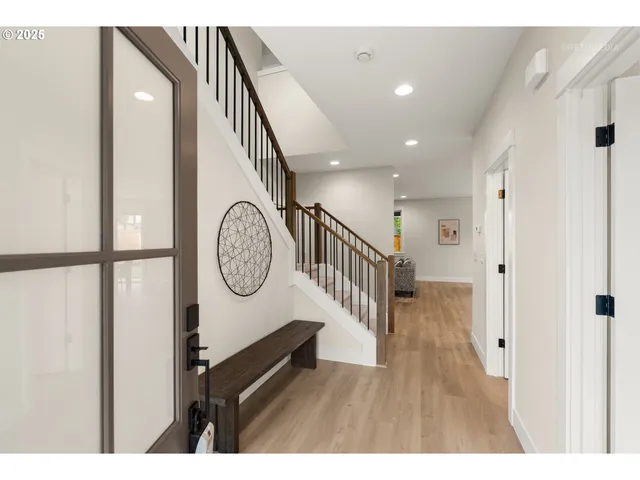 a view of hallway with wooden floor