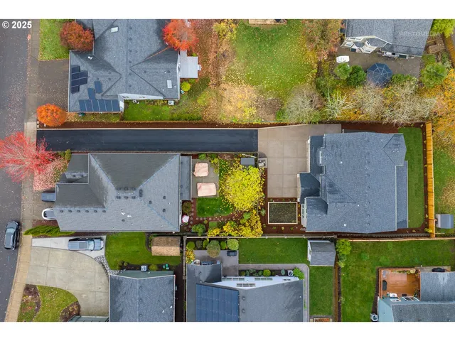 a aerial view of a house with garden space and street view