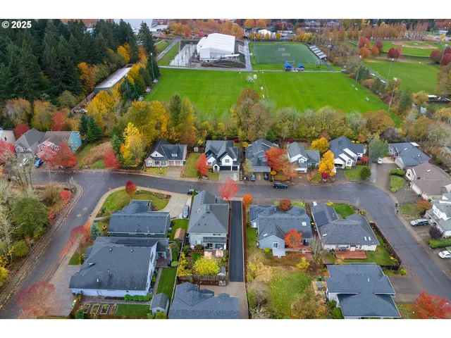 an aerial view of residential houses with outdoor space