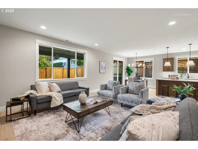 a living room with furniture fireplace and a table