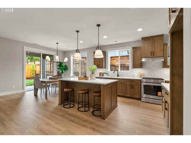 a large kitchen with a table and chairs