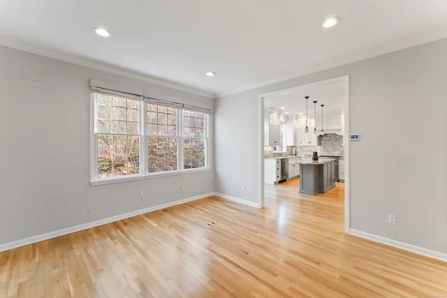 a view of kitchen and hall with wooden floor