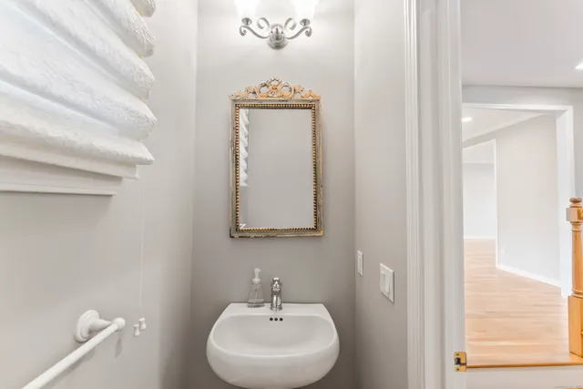 a bathroom with a sink a mirror and a toilet