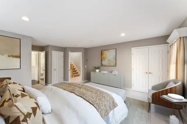 a bedroom with a large bed and a couch