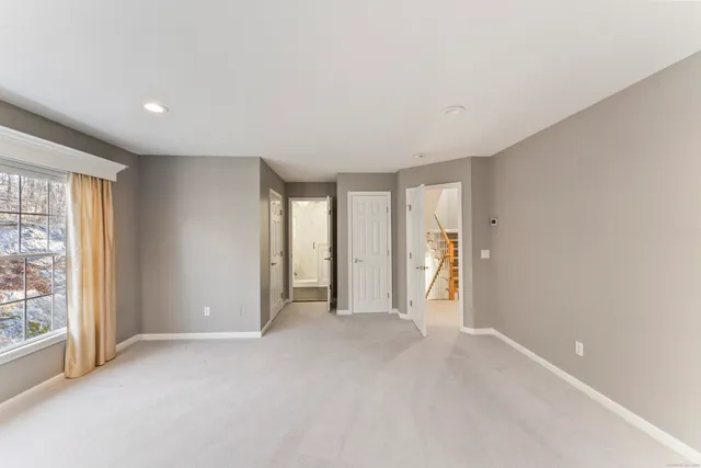 an empty room with windows and closet