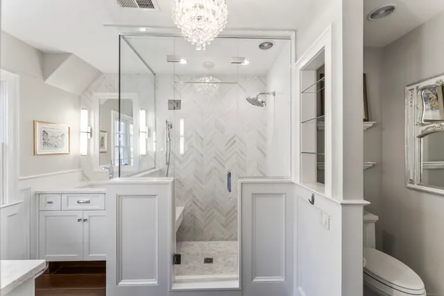 a bathroom with a shower sink and mirror