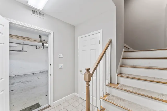 a view of staircase with white walls and railing