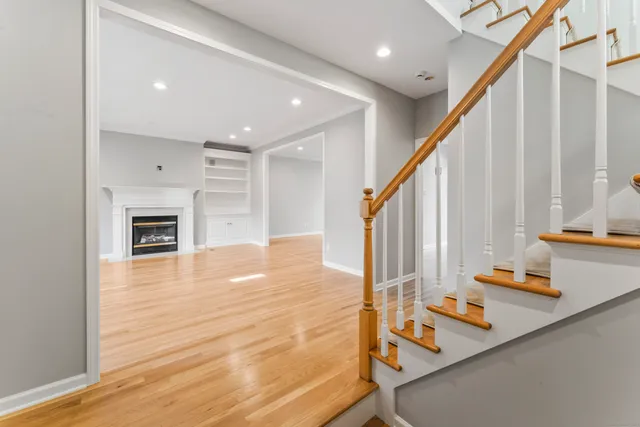 a view of an entryway with wooden floor and staircase